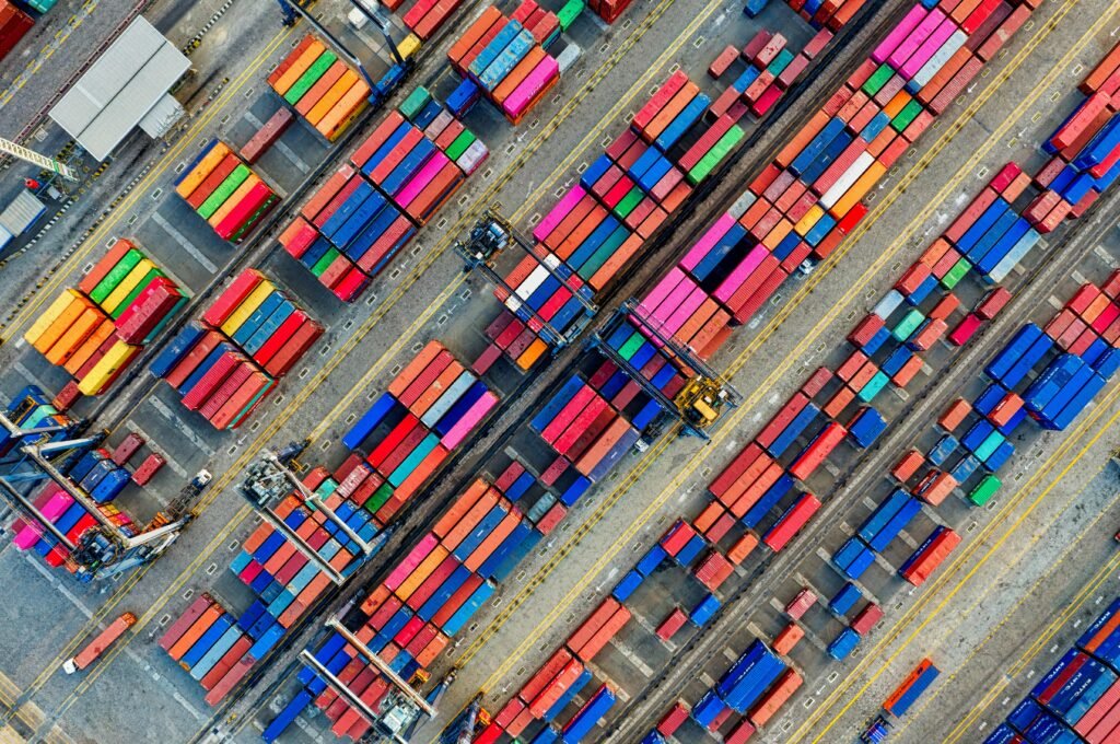 pexels-photo-3063470-3063470 Aerial view of vibrant shipping containers at a busy Jakarta port, showcasing global trade.